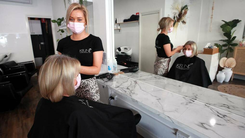 Katie Coote welcomed customers back to The Style Bar on the first day out of lockdown on Saturday. Tracey Bell received a long awaited trim. Picture: Les Smith