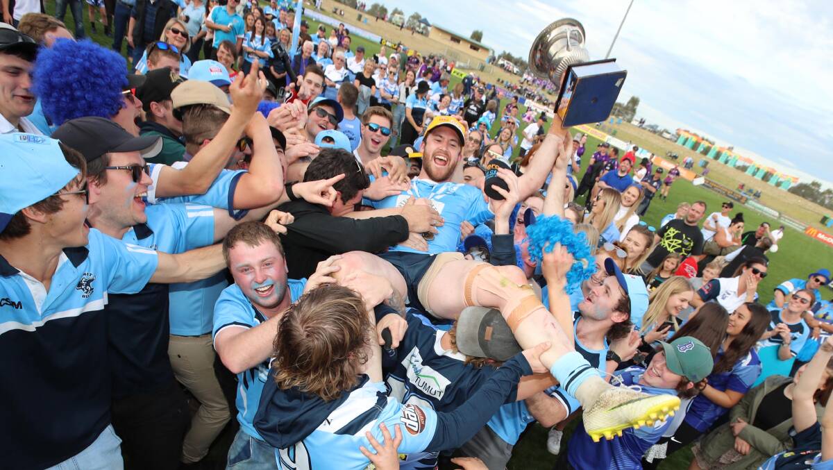 SURF'S UP: Lachlan Bristow crowdsurfs over the Tumut supporters after the Blues' Group Nine grand final win. Picture: Les Smith