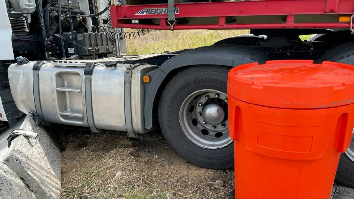 CRACKED: A fuel spill after a truck rolled through a barrier at Tarcutta drew a HAZMAT response from Wagga on Tuesday. Picture: Stewart Alexander, NSW Fire and Rescue