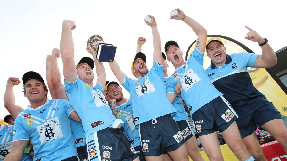 The Blues celebrate after winning the grand final.