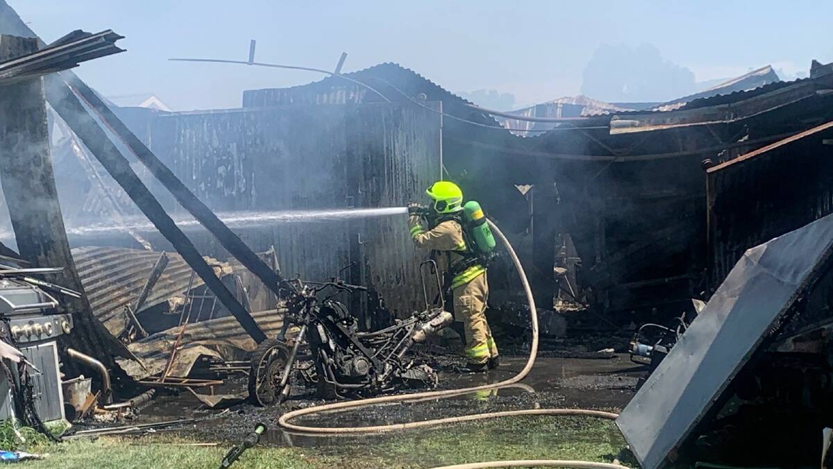 Firefighters work among the ruins of a shed fire in Cootamundra on Wednesday. Picture: NSW Ambulance