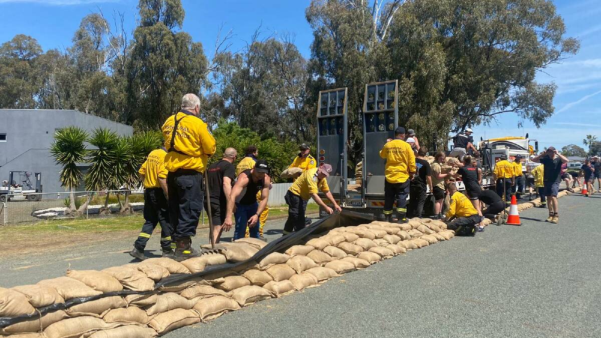 Sandbagging is carried out around critical infrastructure in Moama, which received 125,000 sandbags in three days, at the weekend. Picture by NSW Rural Fire Service