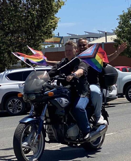 Wagga's Jacqui Kennedy hitches a lift with Emily Saunders from the Sydney chapter of Dykes on Bikes in the Hay Rainbow on the Plains mardi gras parade on Saturday. Picture supplied