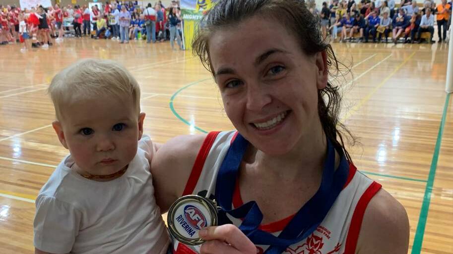 TRIUMPHANT RETURN: Collingullie-Glenfield Park centre and A-reserve player of the grand final Josie Thomas with daughter, Evelyn.