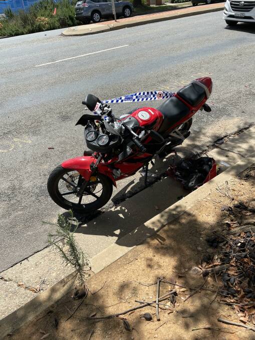 Police tape marks a damaged motorcycle after the crash. Picture: Rex Martinich