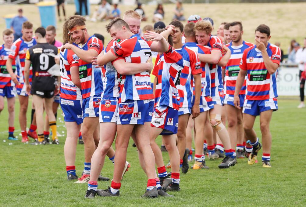 Young players embrace after winning the Weissel Cup grand final.