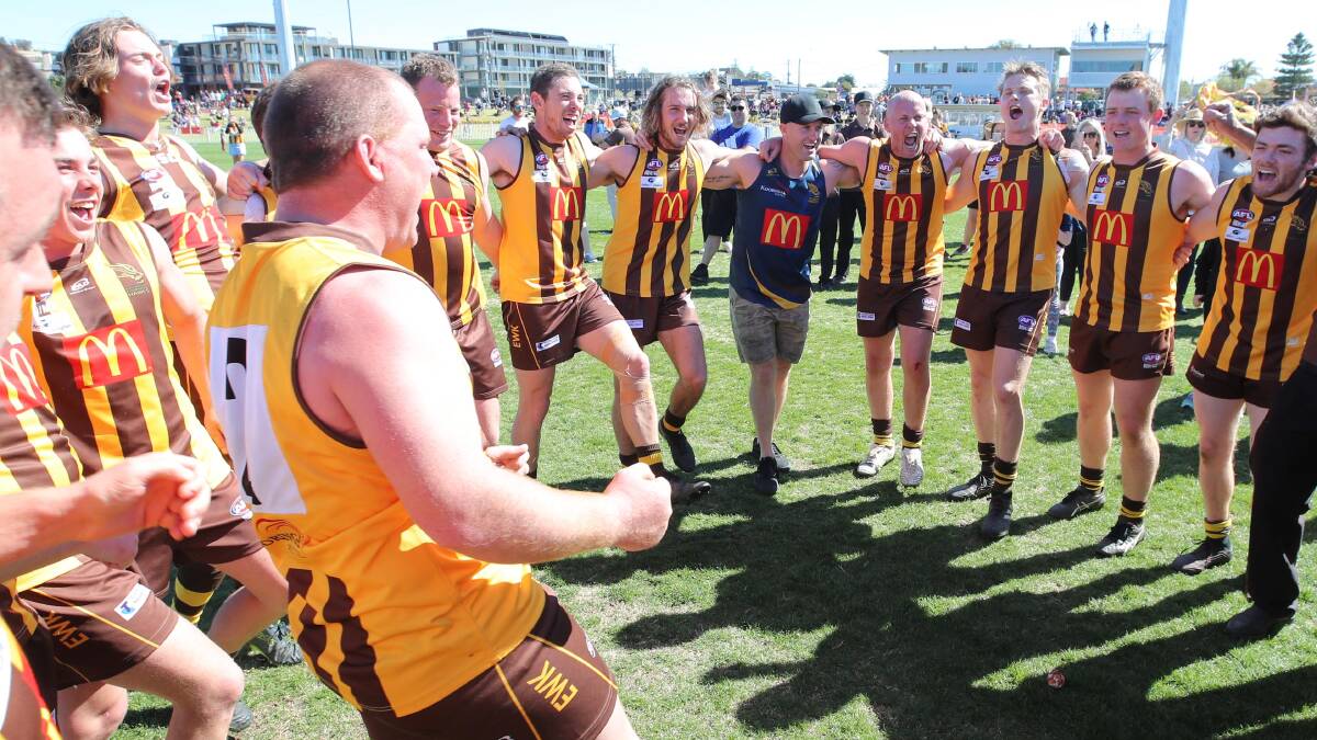 The Hawks roar through the team song after defeating North Wagga in the Farrer League reserve grade grand final. Picture: Les Smith
