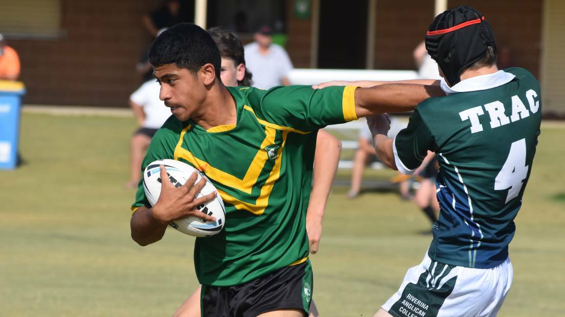 Jacob Iosefa pushes off Dylan Edwards as Mt Austin High and The Riverina Anglican College play out a draw in a 2021 Hardy Shield clash. Picture by Courtney Rees