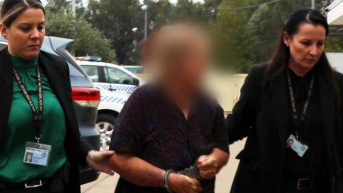 CHARGED: Anne Geeves is arrested at a property near Harden on May 4. Ms Geeves and her former husband, Robert, have been charged with murder. Picture: NSW Police