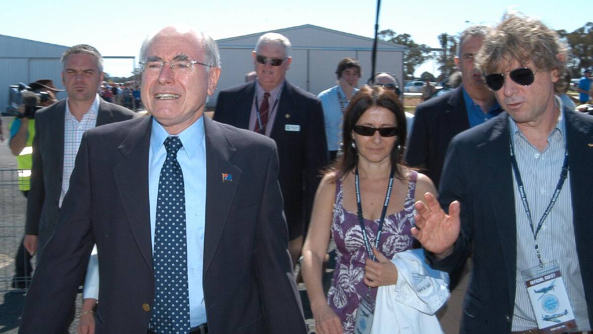 Nigel Judd trails prime minister John Howard and Margo and David Lowy at the opening of the new runway extension at the Temora Aviation Museum in 2006. File image