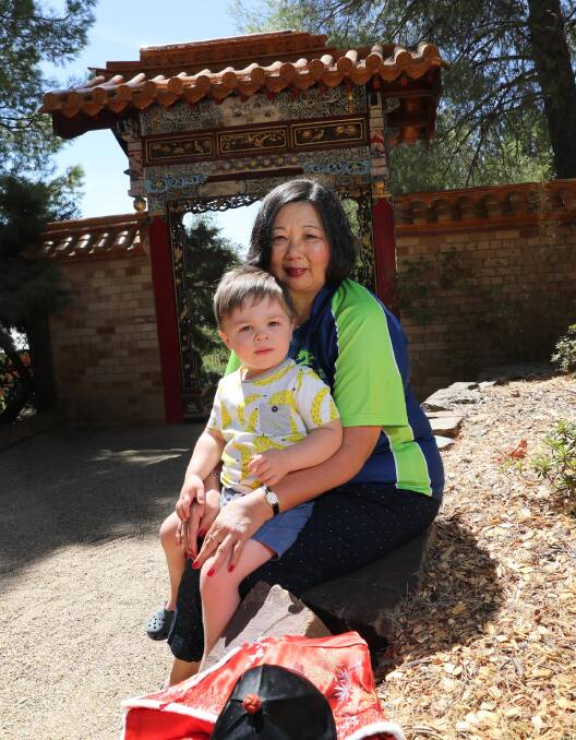 TRADITIONS: Secretary of the Bidgee Dragons Denise Flockton with her grandson Albert Schumach, 2, preparing to celebrate Chinese New Year. Picture: Les Smith
