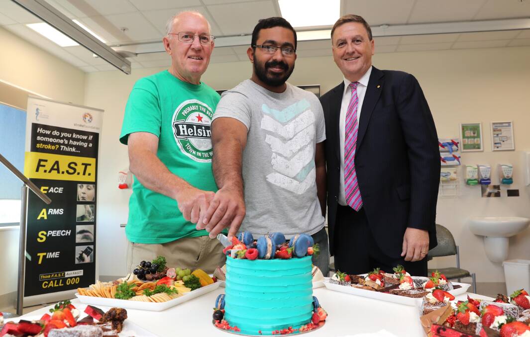 CELEBRATION: Philip Cross, who cares for his stroke-affected wife, Marshal Shaji Jurian, who had a stroke last year, and Neurologist Martin Jude cut the cake at the Acute Stroke Unit's 10th birthday. Picture: Les Smith