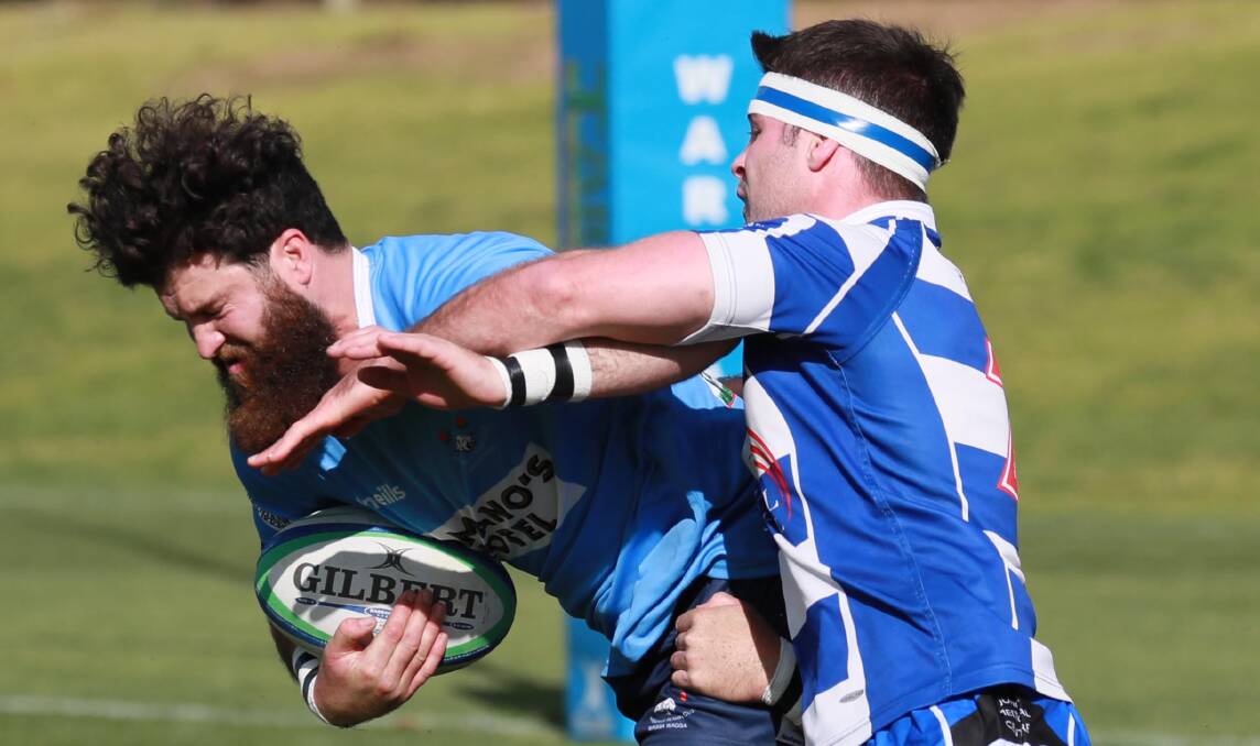 TIGHT CLASH: Rory Sheard tries to bring down Waratahs centre Tom Green as Wagga City scored a late try to extend their winning start to the season. Picture: Les Smith