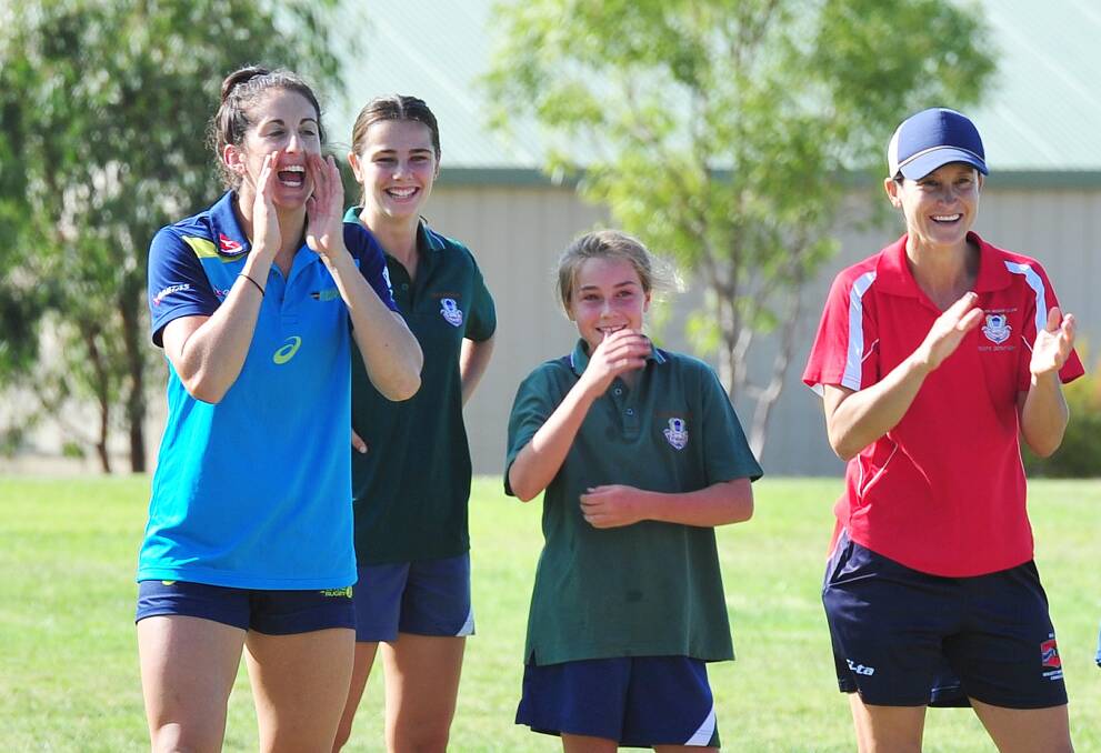 ROLE MODEL: Olympic gold medallist Alicia Quirk (left) gives some encouragement during a training session at The Riverina Anglican College on Monday. Picture: Kieren L Tilly