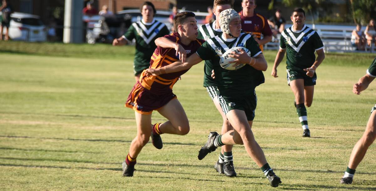 RUNNING RIOT: Tristan Wheeler tries to bring down Western's Braye Porter during Riverina's heavy defeat to start the Laurie Daley Cup Country Championships campaign in Forbes on Saturday.