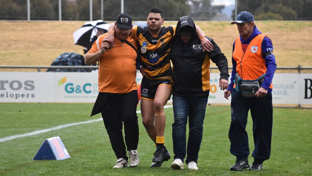 INJURY WORRY: Jack Lyons is helped off after injuring his hamstring in Gundagai's win over Kangaroos at Equex Centre on Saturday. Picture: Courtney Rees
