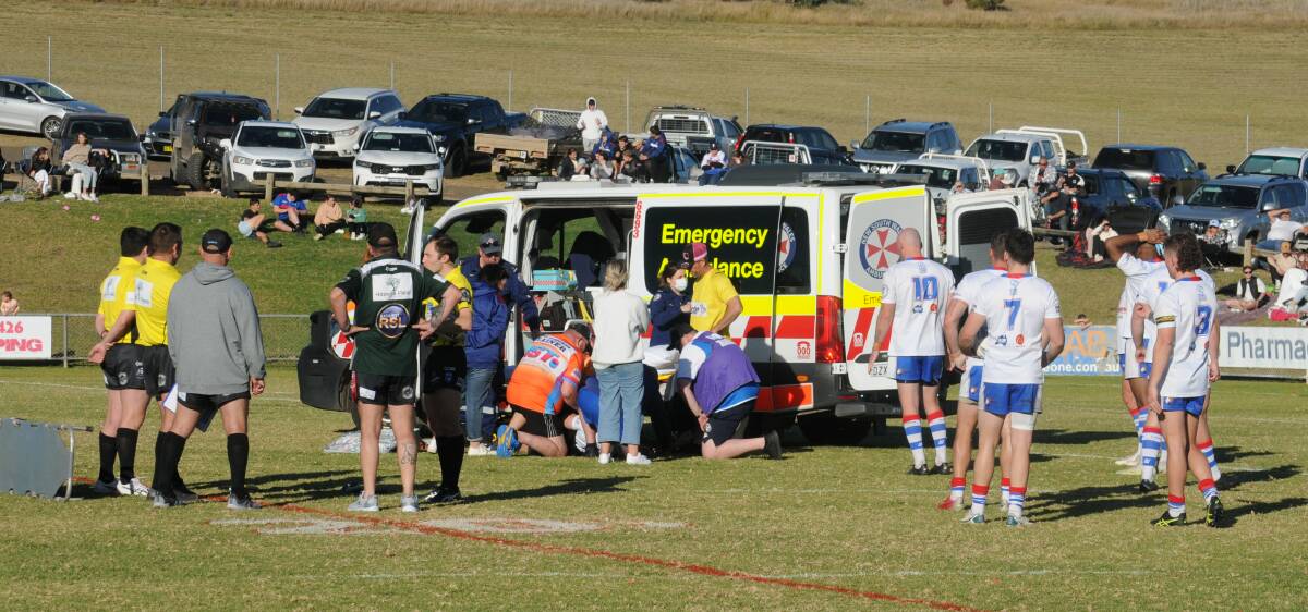 Jake Dooley is treated by paramedics after breaking his leg playing for Parkes last year.