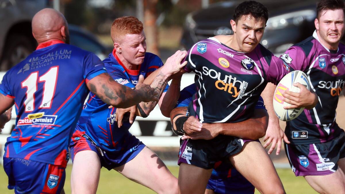 Latrell Siegwalt tries to break out of a tackle during Southcity's win over Kangaroos on Saturday.