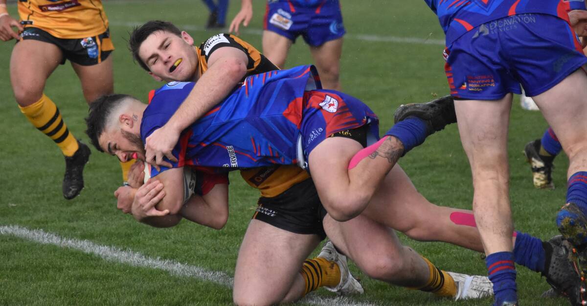 WRAPPED UP: Royce Tout brings Jordan Coleman down as Gundagai extended their winning run against Kangaroos on Saturday. Picture: Courtney Rees