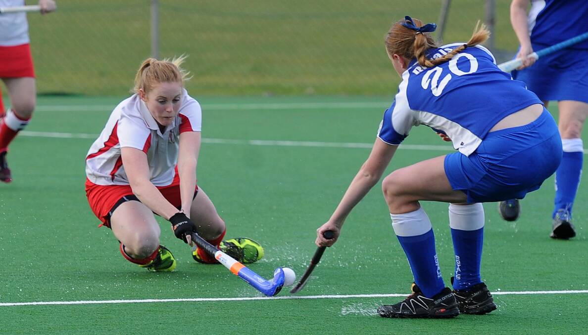 TIGHT CLASH: Aimee Smeeth gets down low trying to stop Lauren Jolliffe from moving the ball forward in the Wagga hockey preliminary final. Picture: Laura Hardwick