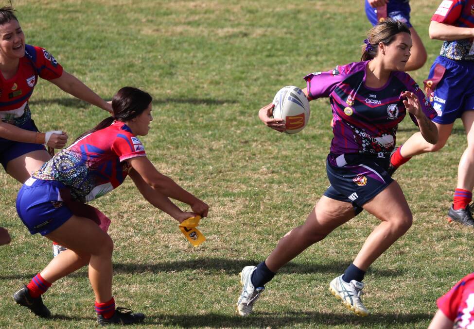 GOT YA: Naomi Reid tags Montana Kearnes in Kangaroos' important win over Southcity on Saturday. Picture: Les Smith