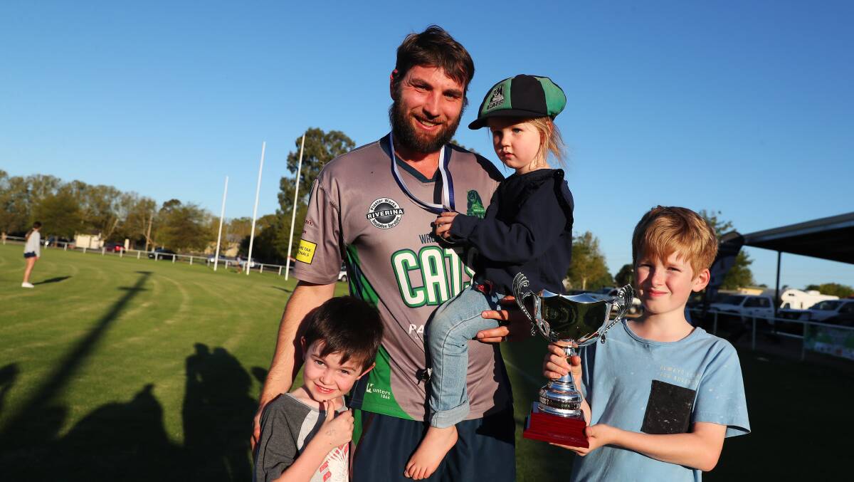 Ron Nicoll celebrates Wagga City's premiership with children Oliver, Willow and Josh.