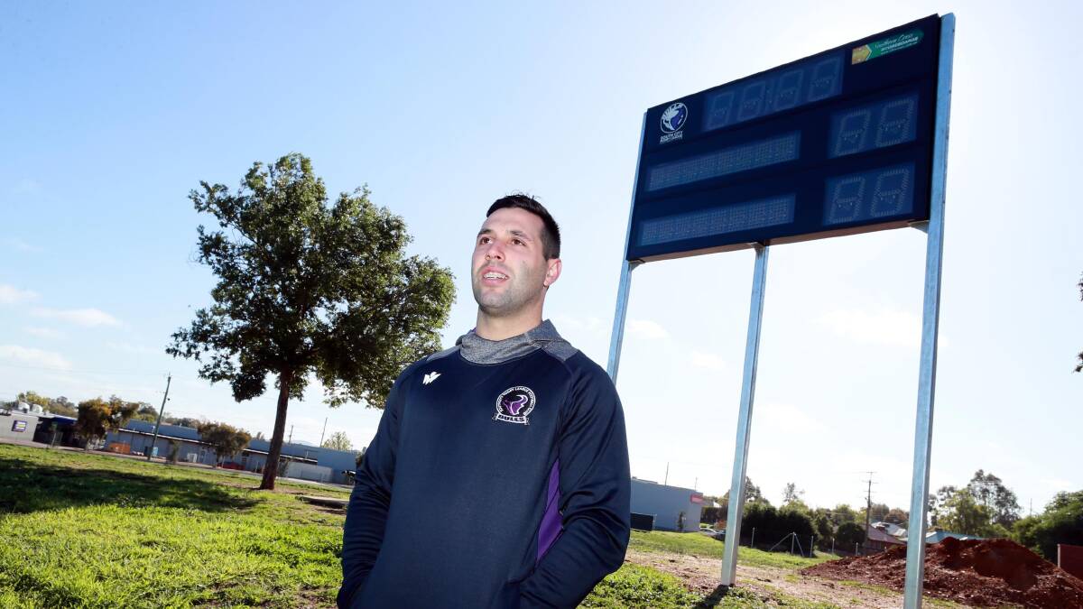 READY TO SHINE: Southcity captain-coach Nathan Rose in front of the new scoreboard at Harris Park. Picture: Les Smith