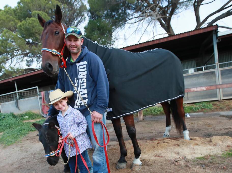 READY TO ROLL: Brett Hogan and Roll Out, pictured with six-year-old daughter Pippa with her pony Turbo, line up in one of the five Regional Championships heats at Riverina Paceway on Friday. Picture: Les Smith