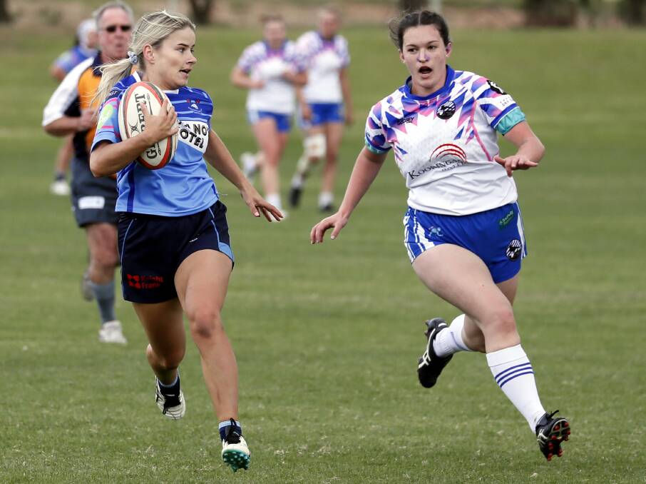 OFF AND GONE: Amy Fowler races away to score a try despite having Teagan McCormack in pursuit as Waratahs took a 27-5 win over Wagga City on Saturday. Picture: Les Smith