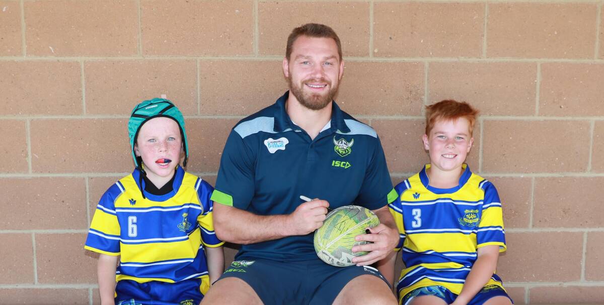 NEW ROLE: South Wagga Public School students Charlie Crowe and Archee Cole with new Canberra Raiders co-captain Elliott Whitehead at Parramore Park on Thursday. Picture: Les Smith
