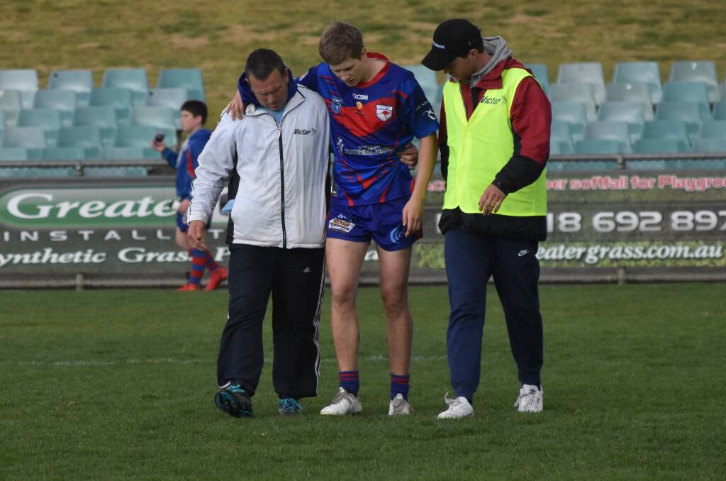 Jake Mascini is helped off after injuring his knee in the loss to Gundagai.