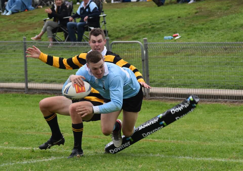 TRY TIME: Gundagai halfback Derek Hay can't stop Tom Hickson from scoring Tumut's final try as the Blues started the season with a win at Twickenham on Saturday. Picture: Courtney Rees