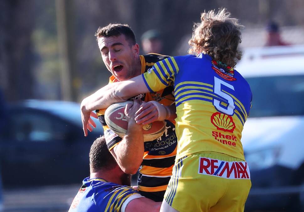 INJURY WORRY: Gundagai captain-coach James Smart come off second best from this tackle from Tom Diggins and Damon Jackson on Sunday. Picture: Emma Hillier