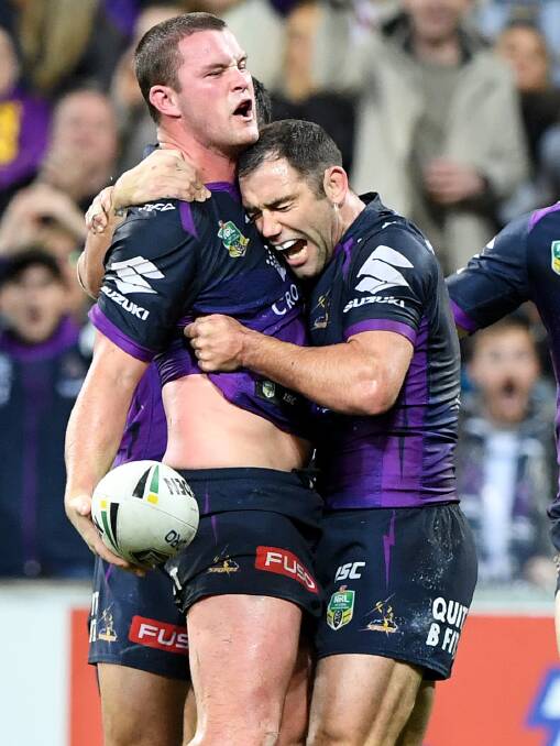 SPECIAL MOMENT: Temora product Joe Stimson celebrates with Melbourne Storm captain Cameron Smith after scoring the match-winning try against the Roosters on Saturday.