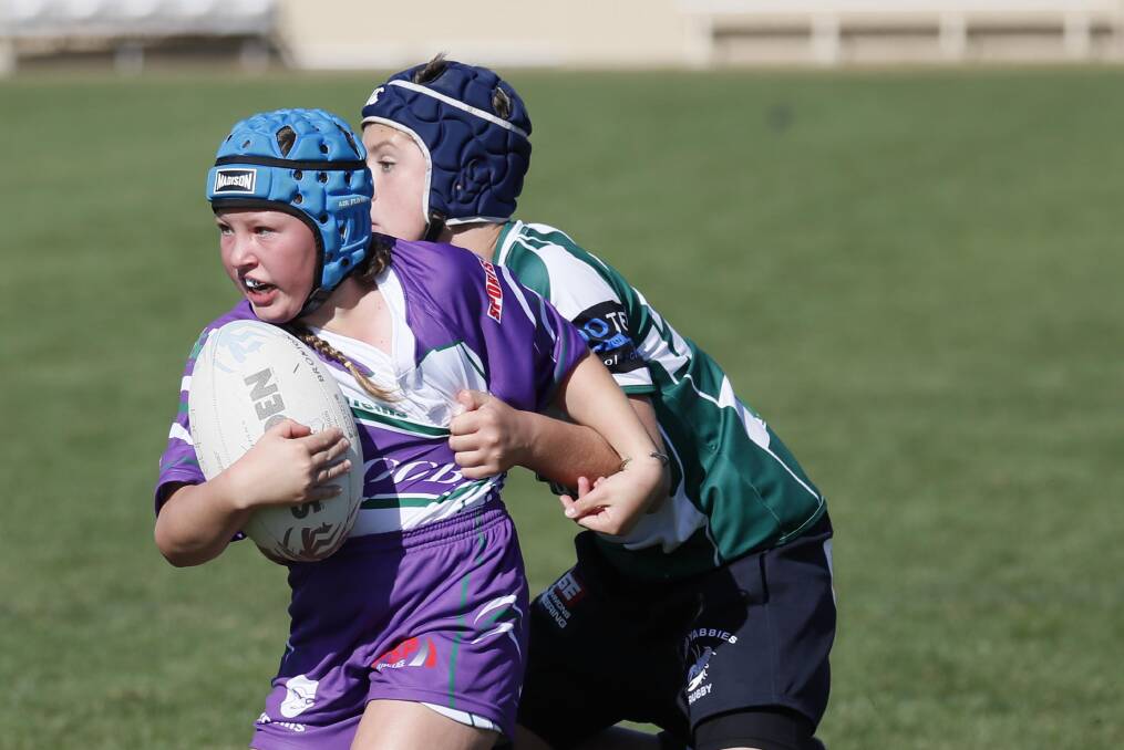ON THE CHARGE: Indie Dunn tries to break out of a tackle during an under 12s game as part of the junior rugby union gala day at Parramore Park on Sunday. Picture: Les Smith