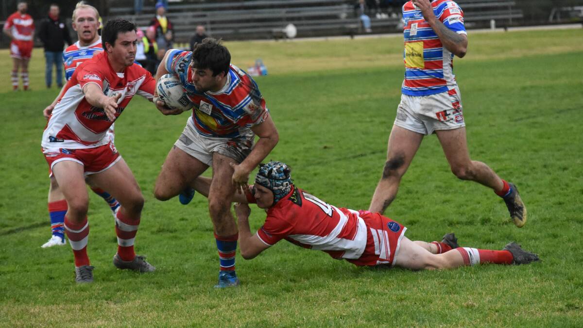 LINE IN SIGHT: Gus Smith tries to break out of James Stewart's tackle attempt on his way to scoring for Young at Alfred Oval on Sunday. Picture: Courtney Rees