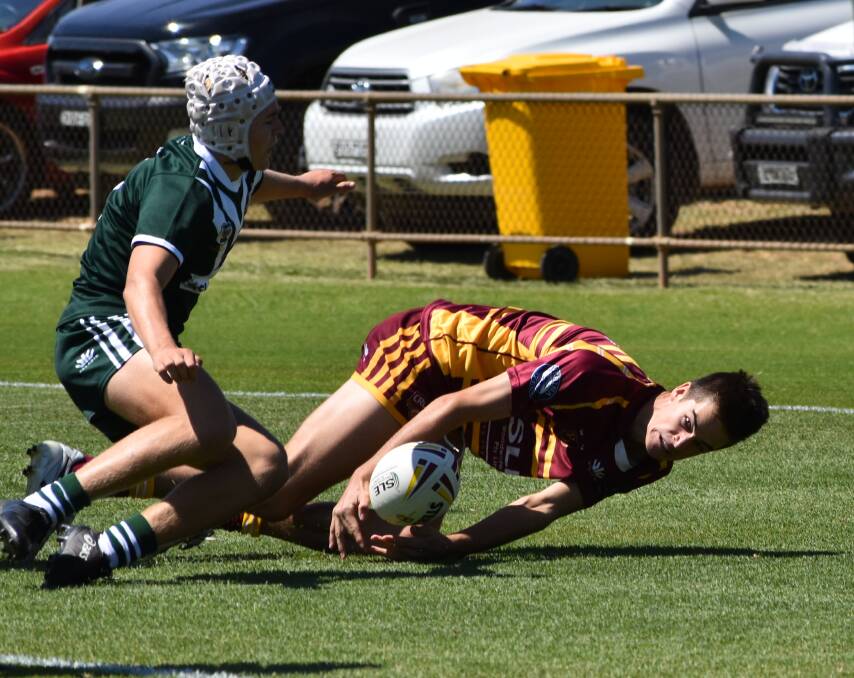 JUGGLING ACT: Cootamundra's Ben Rumble manages to control a Bobby Jones kick to get Riverina on the board in the Andrew Johns Cup loss to Western at West Wyalong on Saturday. Picture: Courtney Rees
