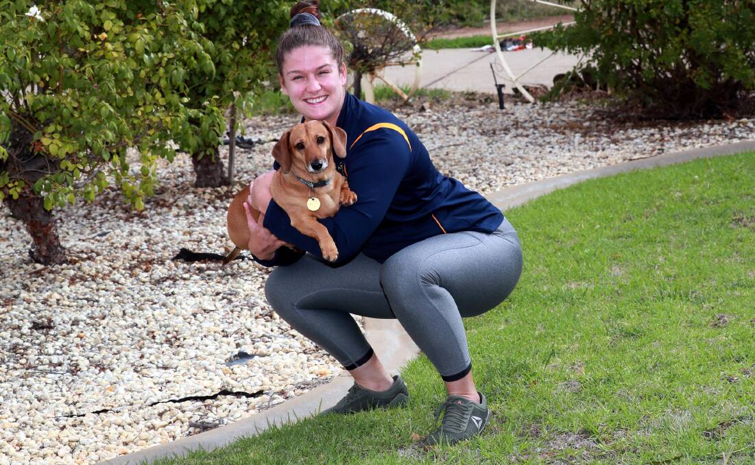 EXTRA WEIGHT: ACT Brumbies hooker Harriet Elleman has been using dog Waffles to help train before the Super W season was halted. Picture: Les Smith