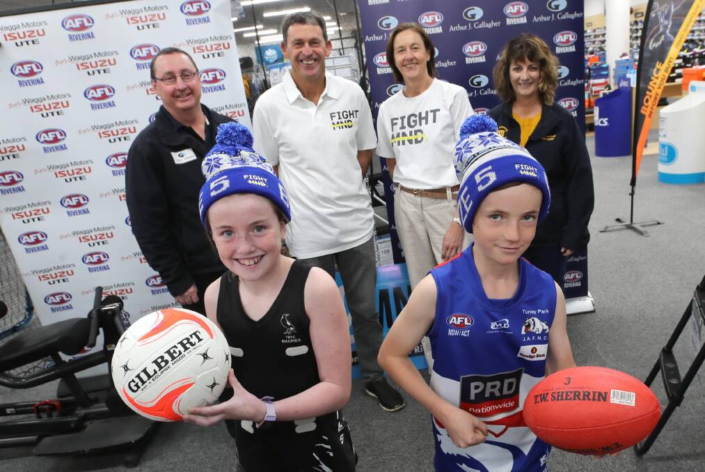 SPECIAL CAUSE: AFL Riverina operations manager Shane Buchanan, Chris Daniher, Julie Cornell and Hume League netball president Julianne Clancy with Aly Mazzocchi, 10, Ollie Stout, 9, ahead of the Sock It To MND round later this month. Picture: Les Smith