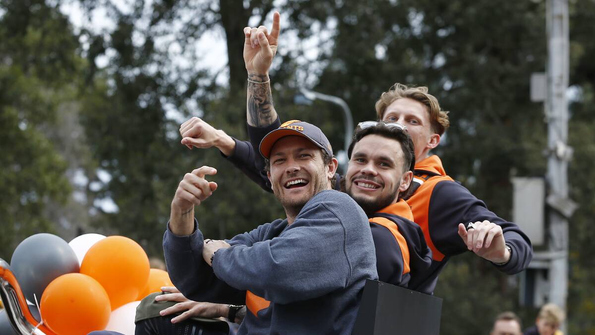 BUILD UP: Narrandera's Zac Williams (centre) with Giants temmeates Lachie Whitfield and Sam Reid during the AFL grand final parade on Friday. Picture: Getty Images