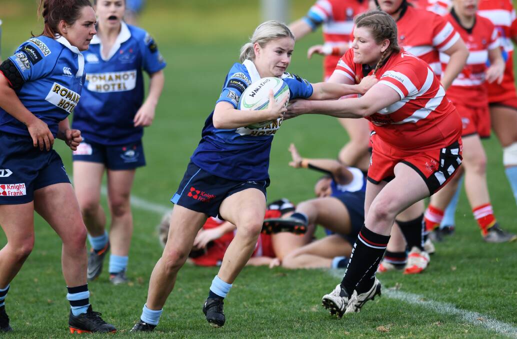 STRONG PERFORMANCE: Amy Fowler tries to push off the CSU defence as Waratahs scored a big win to upset the premiers in the top of the table clash at Conolly Rugby Complex on Saturday.