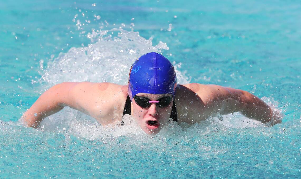 STRONG SWIM: Annabella Storer, 13, from Mater Dei Catholic College, on the way to setting a new record in the 50 metres butterfly at the BISSA carnival at Oasis on Thursday. Picture: Kieren L Tilly