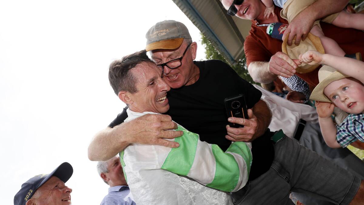 Part-owner David McIntyre celebrates with Danny Beasley after he rode Carnival Miss to victory in the Tumbarumba Cup on Saturday. Picture by Les Smith