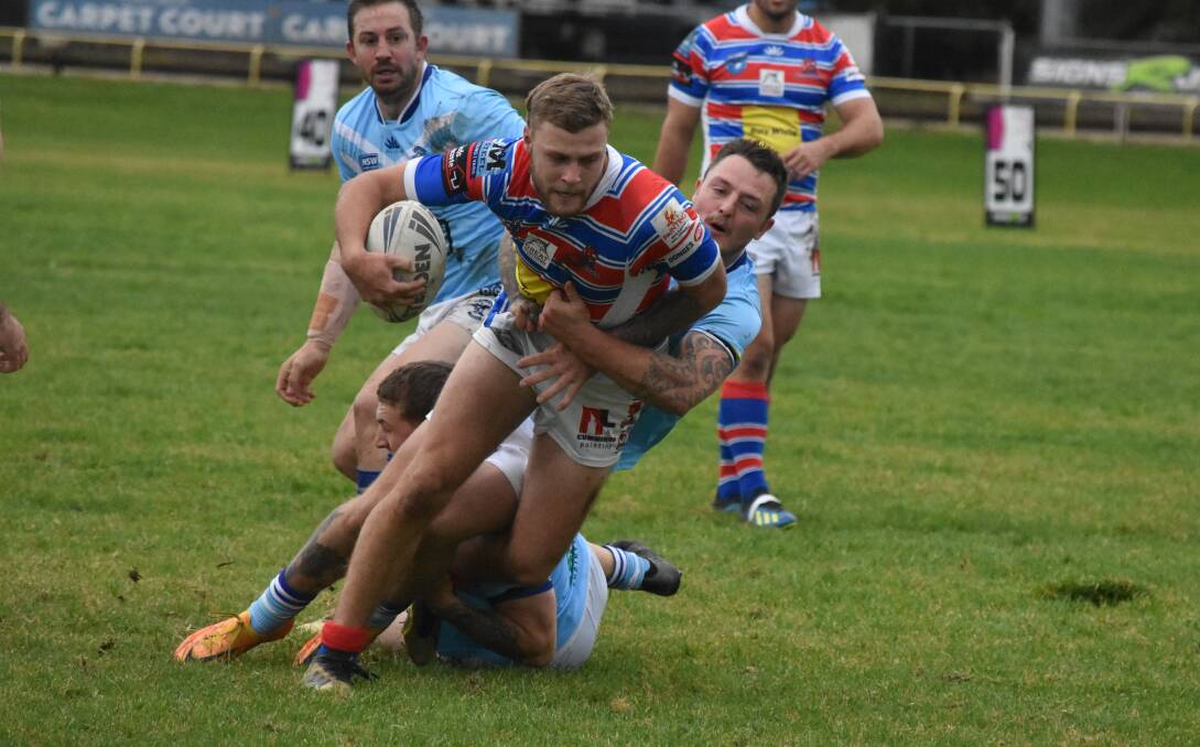 LEADING THE WAY: Nic Hall tries to break out of Jordan Anderson's tackle attempt in Young's tight win over Tumut at Alfred Oval on Sunday to see them remain unbeaten. Picture: Courtney Rees
