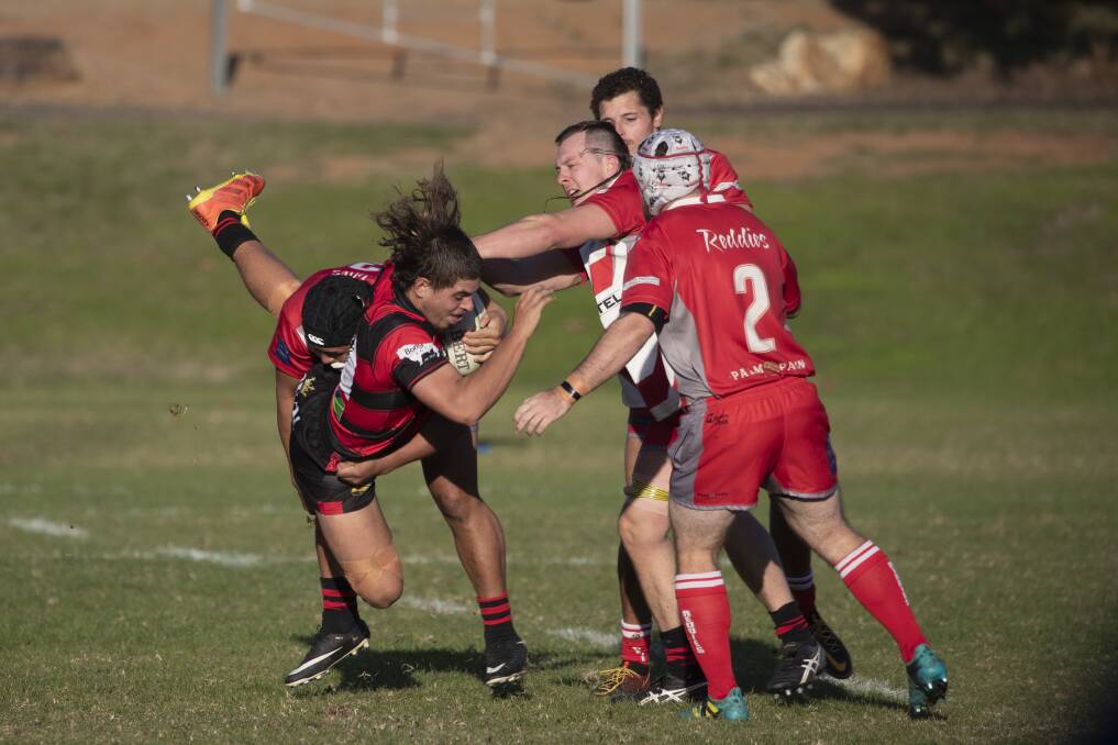 BIG HIT: Connor Swann is tackled by Aisea Lokotui Taukinukufili during Tumut's tight win over CSU at Beres Ellwood Oval on Saturday. Picture: Madeline Begley