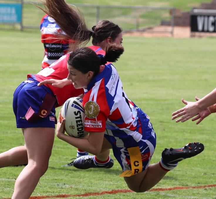 CLOSE CONTACT: Young's Chloe Muggleton is stopped in her tracks by Kangaroos player Molly Antone in their clash to start the Group Nine leaguetag season. Picture: Les Smith