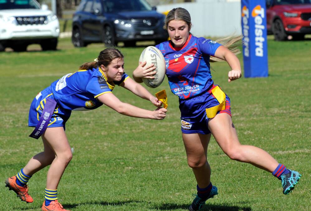 GOT HER: Milly Lucas is stopped by the Junee defence as Kangaroos ran out 48-0 winners at Laurie Daley Oval on Saturday. Picture: Sean Cunningham