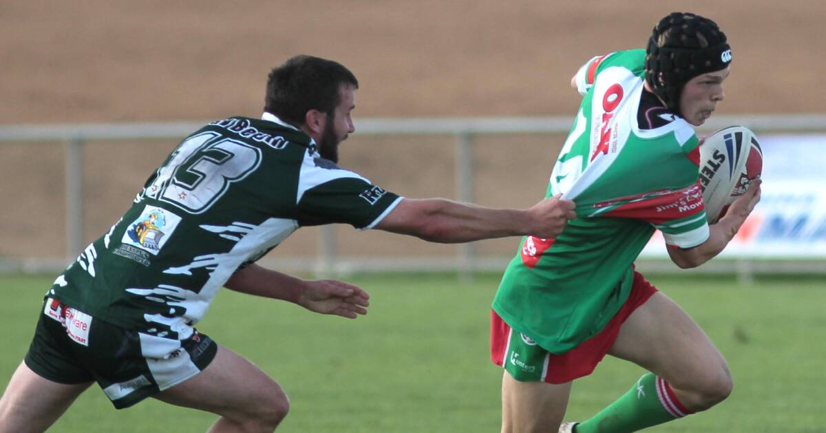 HOLDING ON: Luke Murray tries to escape the clutches of Tumbarumba's Todd Bremner as Brothers post its first win of the season on Saturday. Picture: Les Smith
