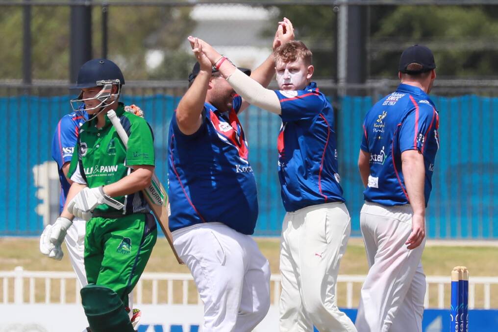 GOT HIM: Stuart Slocombe and Beck Frostick celebrate the important wicket of Josh Thompson as St Michaels continued their winning ways against Wagga City on Saturday. Picture: Les Smith