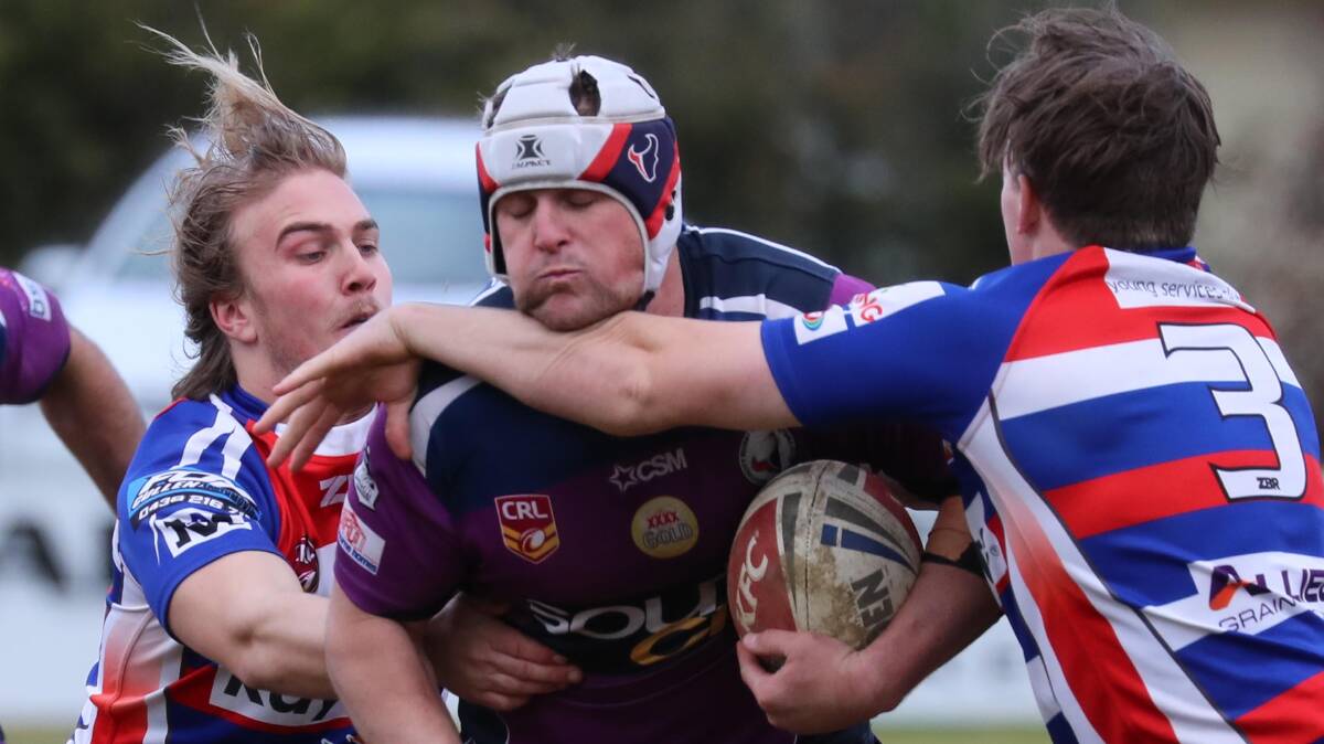 HEAVY CONTACT: Young's Nick Bush and Will Scott work to bring down Mitch Curran in Southcity's win at Harris Park on Saturday. Picture: Les Smith